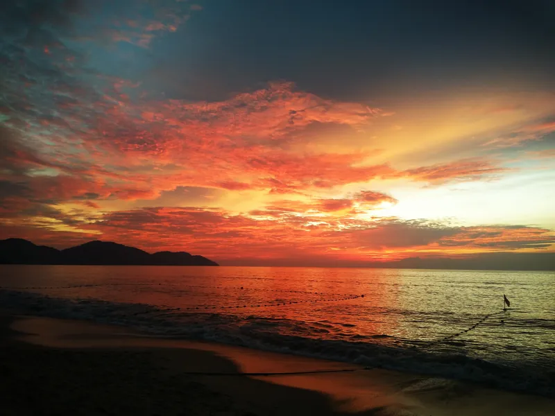 Late afternoon light on Batu Ferringhi beach, looking toward the headland
